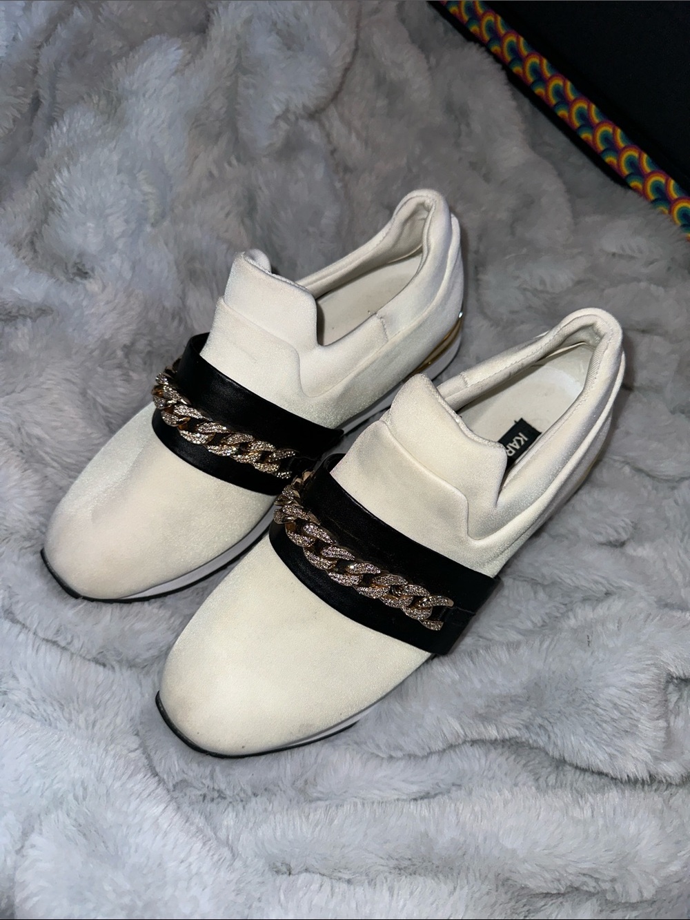 Karl Lagerfeld Cream Slip-On Sneakers with Black Strap and Gold Chain Accent